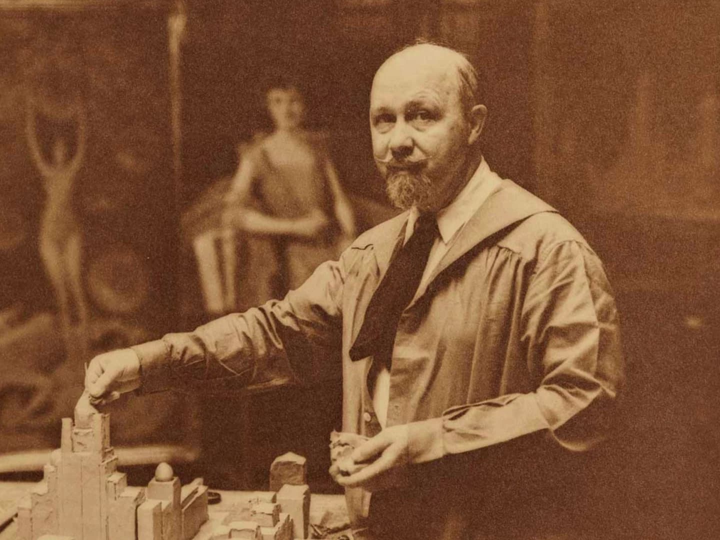 Archival portrait of Walter Russell working on a sculptural model in the full documentary episode